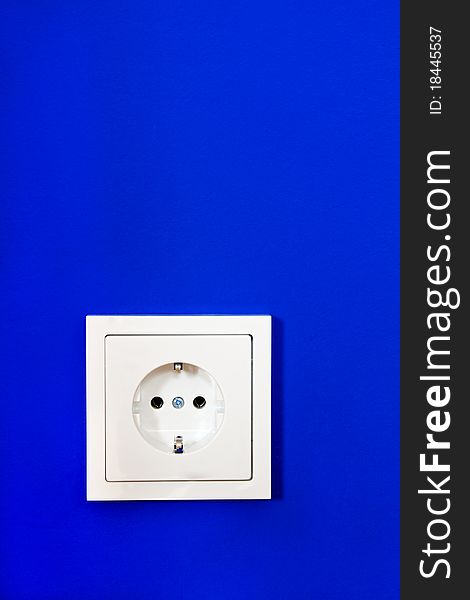 Electrical outlet on blue painted wall. Electrical outlet on blue painted wall