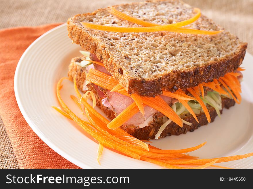 Tasty open sandwich with cucumber relish, smoked beef pastrami and sliced carrots on wholewheat bread. Tasty open sandwich with cucumber relish, smoked beef pastrami and sliced carrots on wholewheat bread