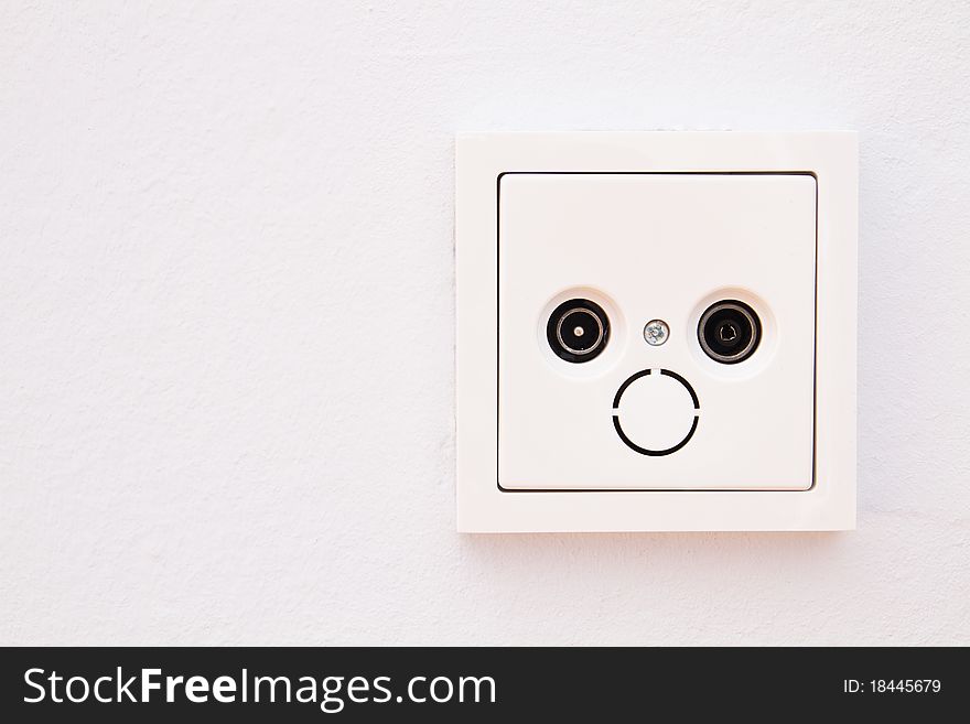 Antenna outlet on a white painted wall. Antenna outlet on a white painted wall