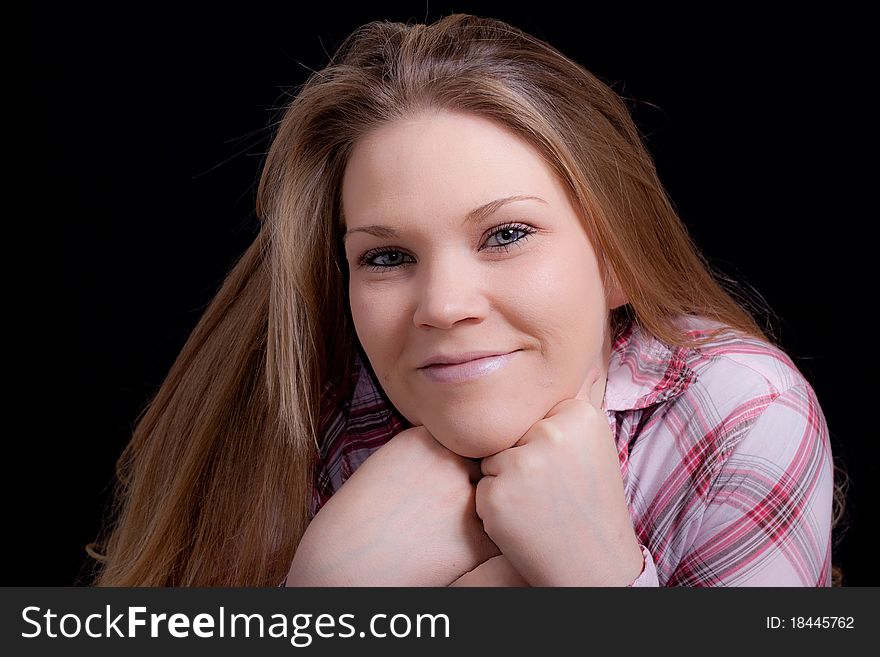 A beautiful blond girl wearing pink. There is a black background. A beautiful blond girl wearing pink. There is a black background.