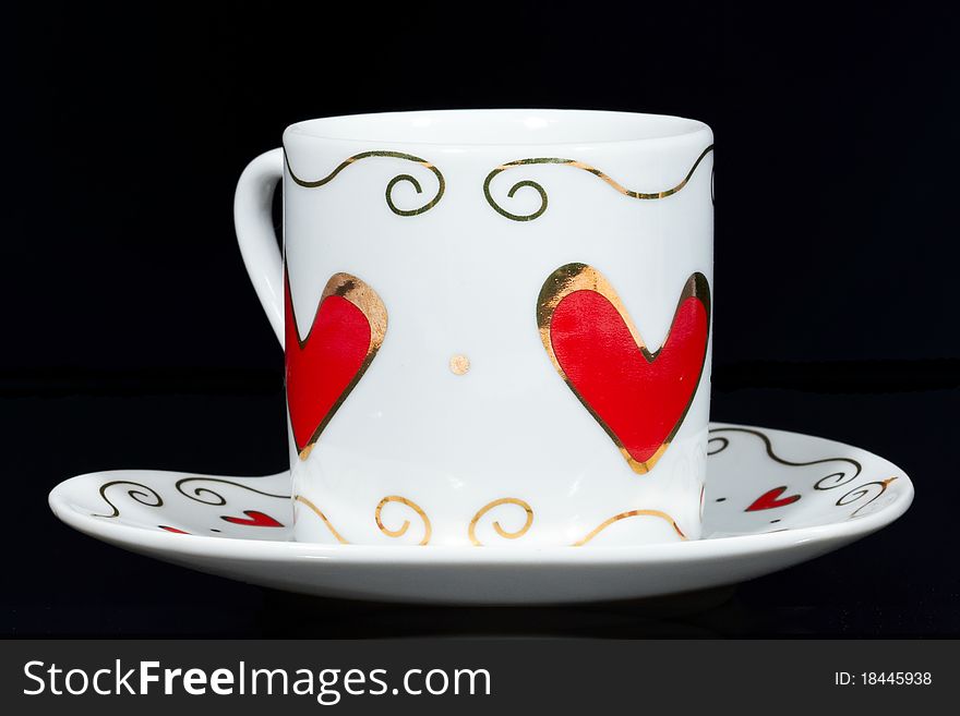 White cup with hearts.