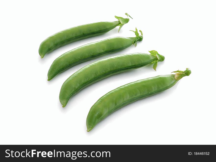 Pea pods. Green peas on a white background close-ups.