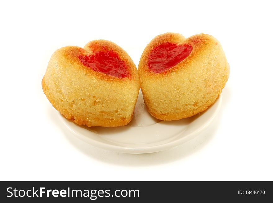 Baking flour in the form of hearts with jam isolated on a white background