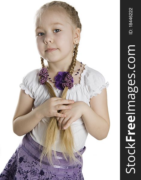 Little girl blonde with long plaits on a white background