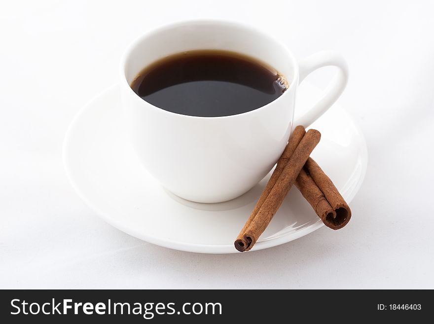 Coffee cup and cinnamon sticks