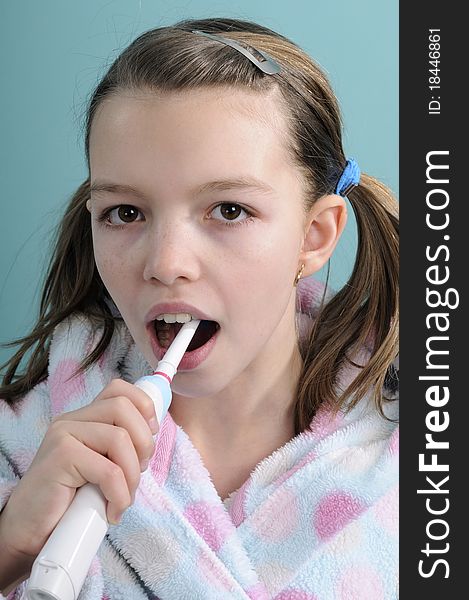 Caucasian child dressed in bathrobe washing tooth. Caucasian child dressed in bathrobe washing tooth