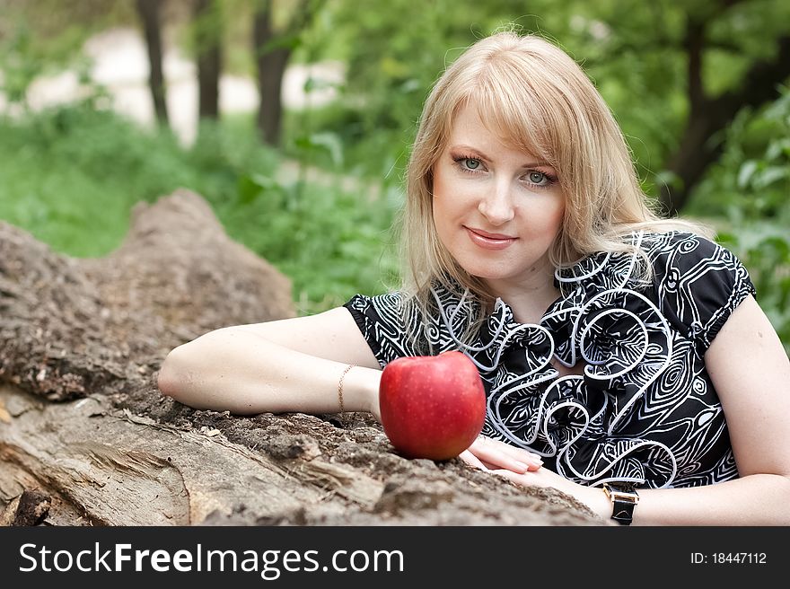 Beautiful Smiling Young Woman With Red Apple In He