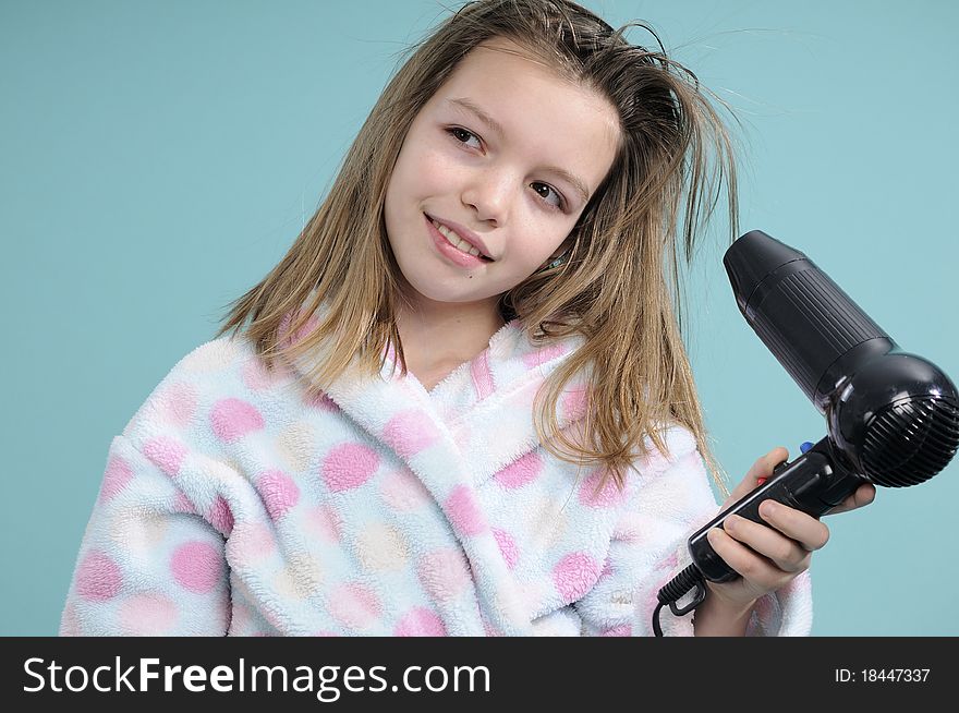 White girl dressed in bathrobe drying hair flying with dryer. White girl dressed in bathrobe drying hair flying with dryer