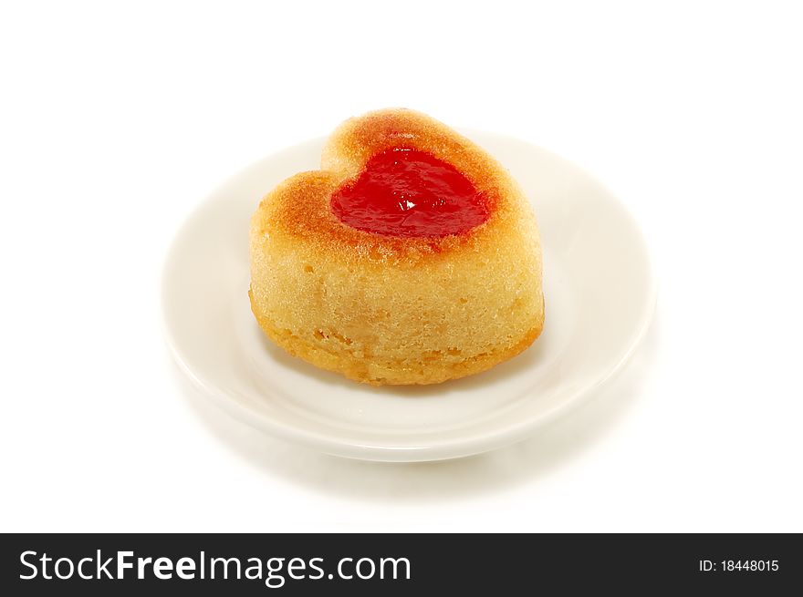Cake with jam in a heart isolated on white background