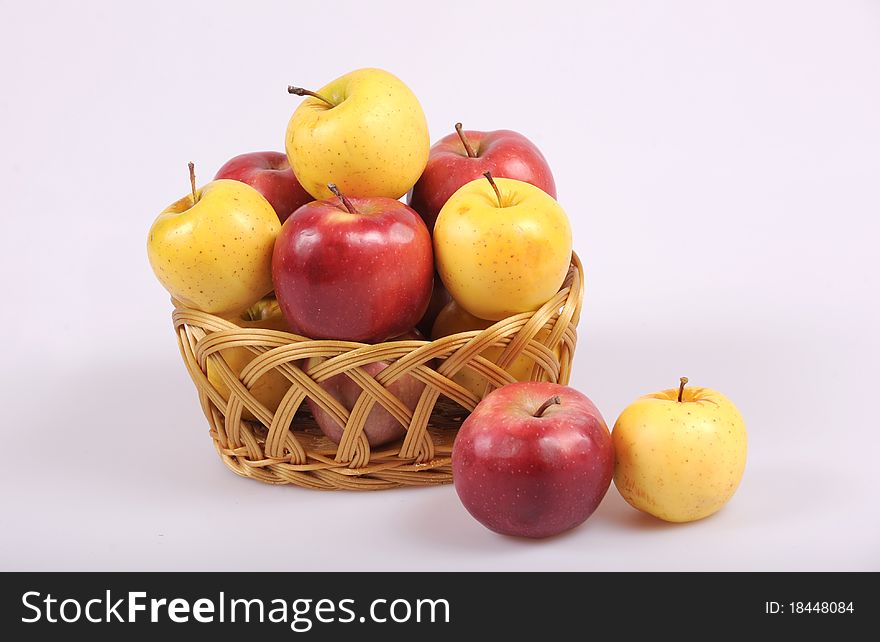Colored red and yellow apples in basket