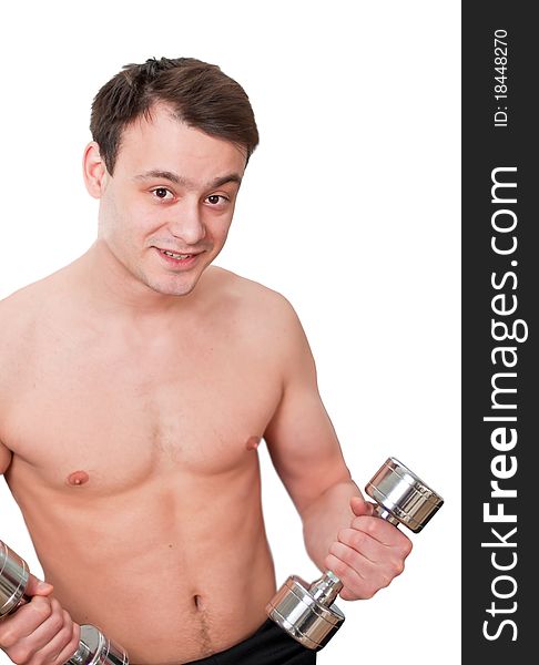 Young man with naked torso with dumbbells in sport club on white