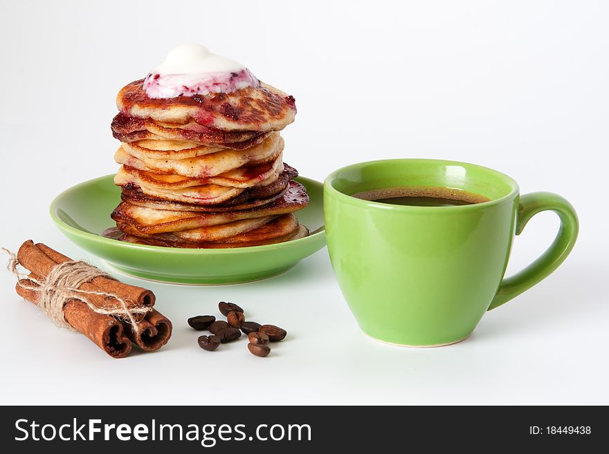 Delicious pancakes with cream and jam and a cup of coffee. Delicious pancakes with cream and jam and a cup of coffee