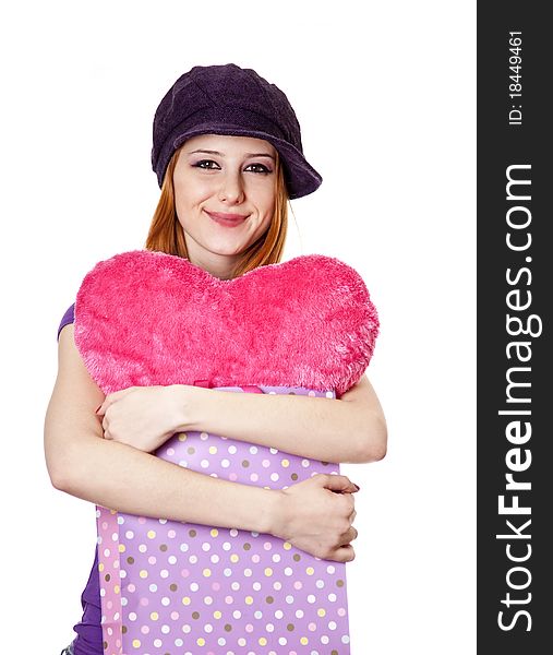Beautiful red-haired girl with heart in bag. Studio shot.
