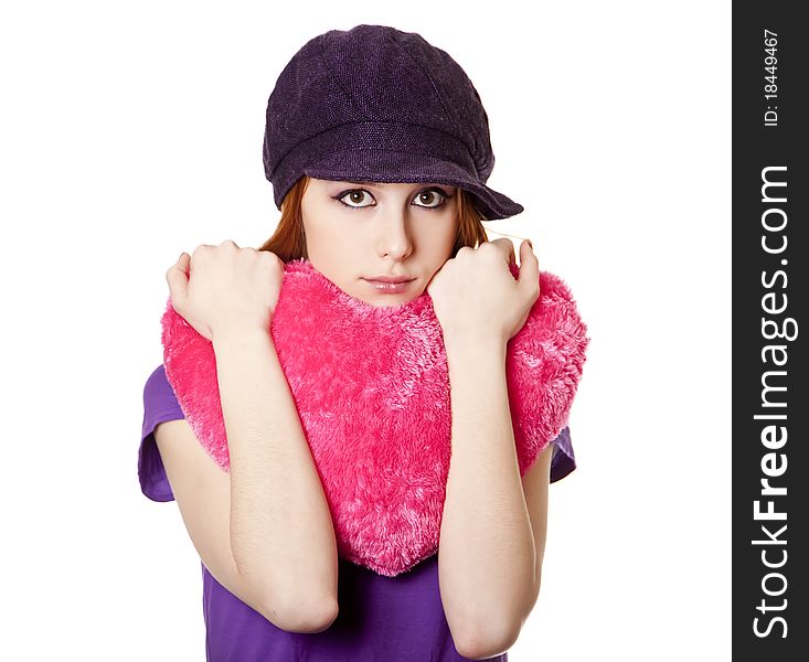 Beautiful red-haired girl with toy heart. Studio shot.