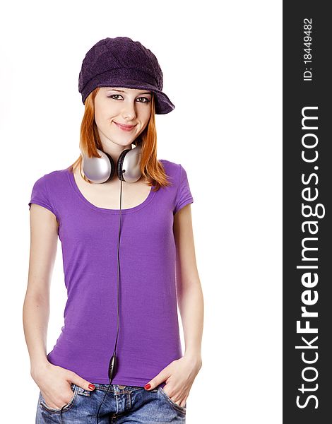 Beautiful red-haired girl with headphones. Studio shot.