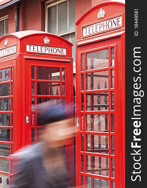 Passing in the foreground, the background red phone boxes in London. Passing in the foreground, the background red phone boxes in London