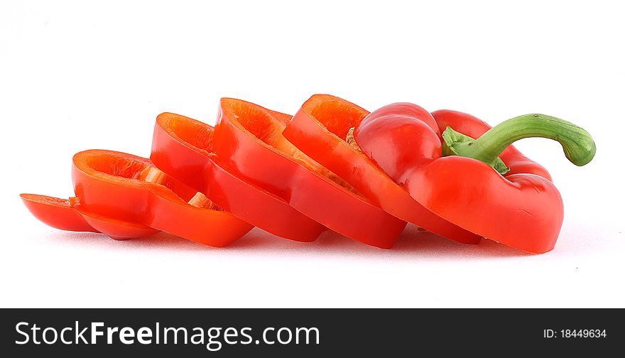 Red bell peppers are cut into slices and isolated.