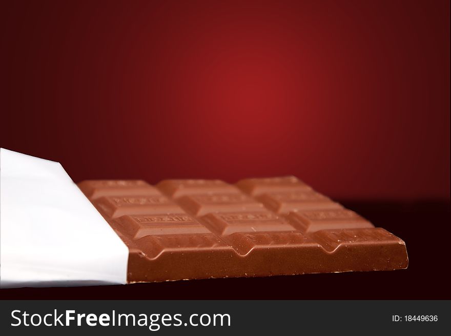 Chocolate in bar with open white cover