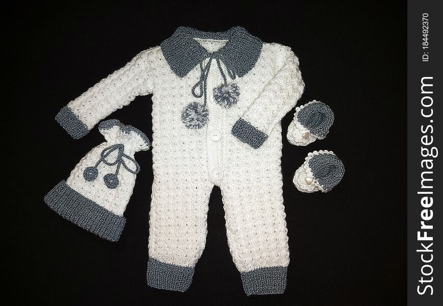 Handmade knitted newborn set for baby boy, in white-gray: romper, hat and booties. Handmade knitted newborn set for baby boy, in white-gray: romper, hat and booties.