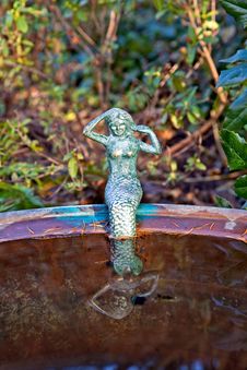 Little Mermaid Sitting On The Edge Of A Basin Royalty Free Stock Image