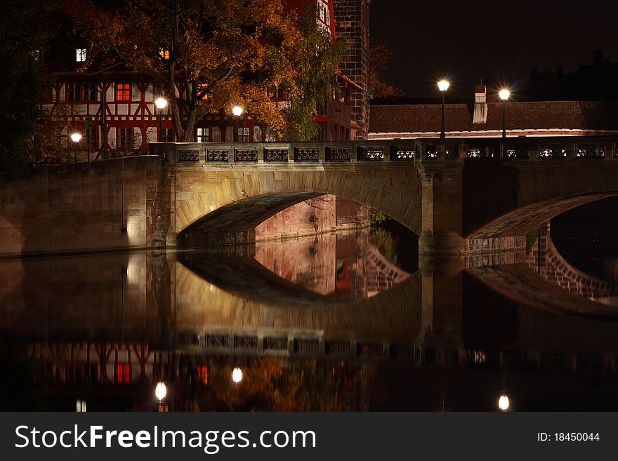 Bridge over river at night in Nuremberg Germany