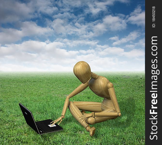 Very high resolution 3d rendering of a wooden mannequin working with his notebook sitting on the grass. Very high resolution 3d rendering of a wooden mannequin working with his notebook sitting on the grass