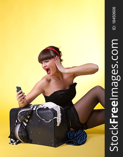 Young woman with broken baggage scream on cell