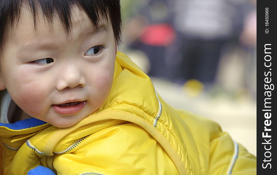 A happy baby is playing in a park. A happy baby is playing in a park