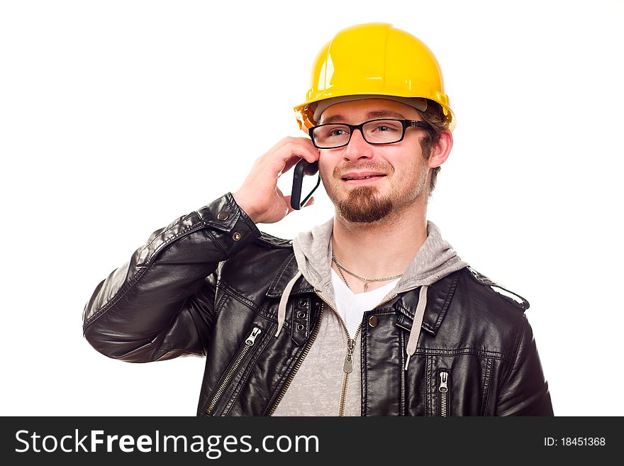 Handsome Young Man in Hard Hat Talking on Cell Phone Isolated on a White Background. Handsome Young Man in Hard Hat Talking on Cell Phone Isolated on a White Background.