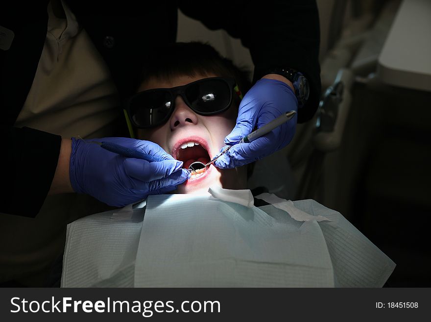 Young boy getting a examination at the dentist