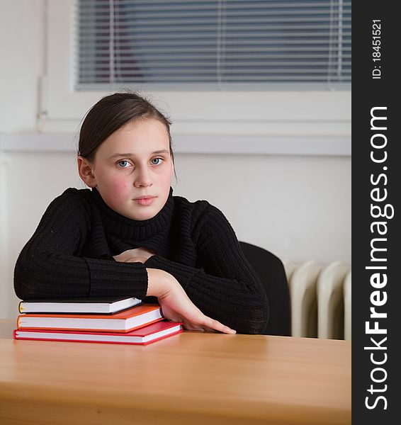 Young cute teen, seated at the table