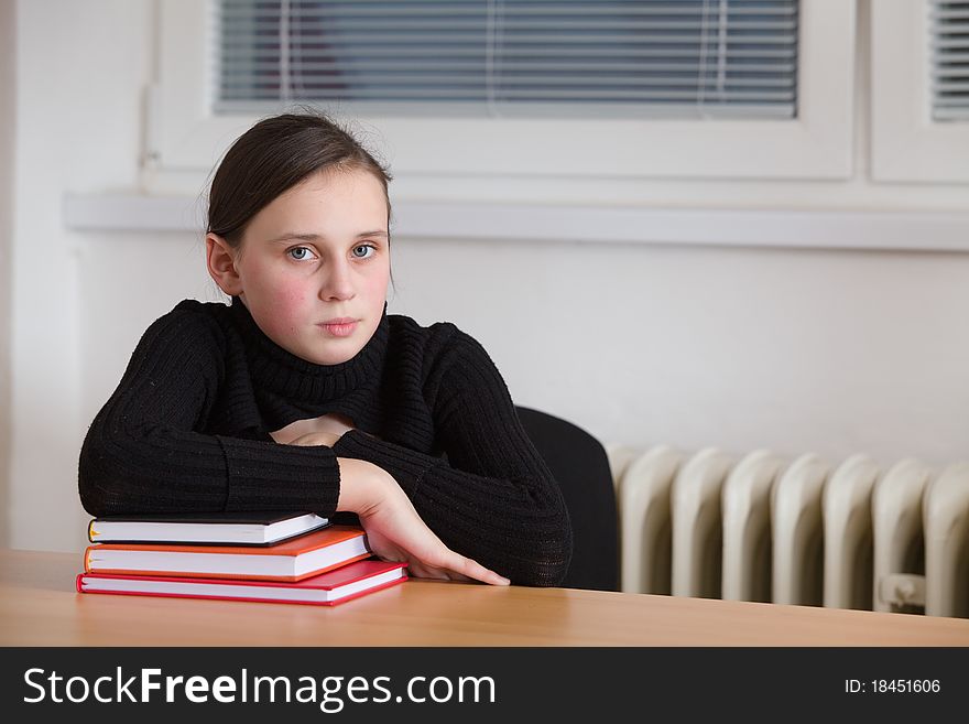 Young cute teen, seated at the table