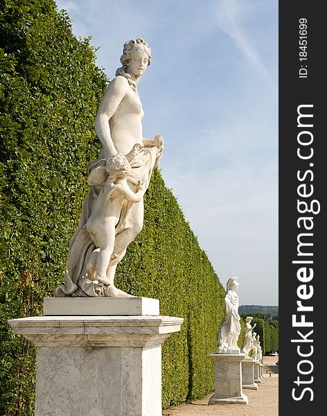 Statue on a path of Versailles garden， Paris France。