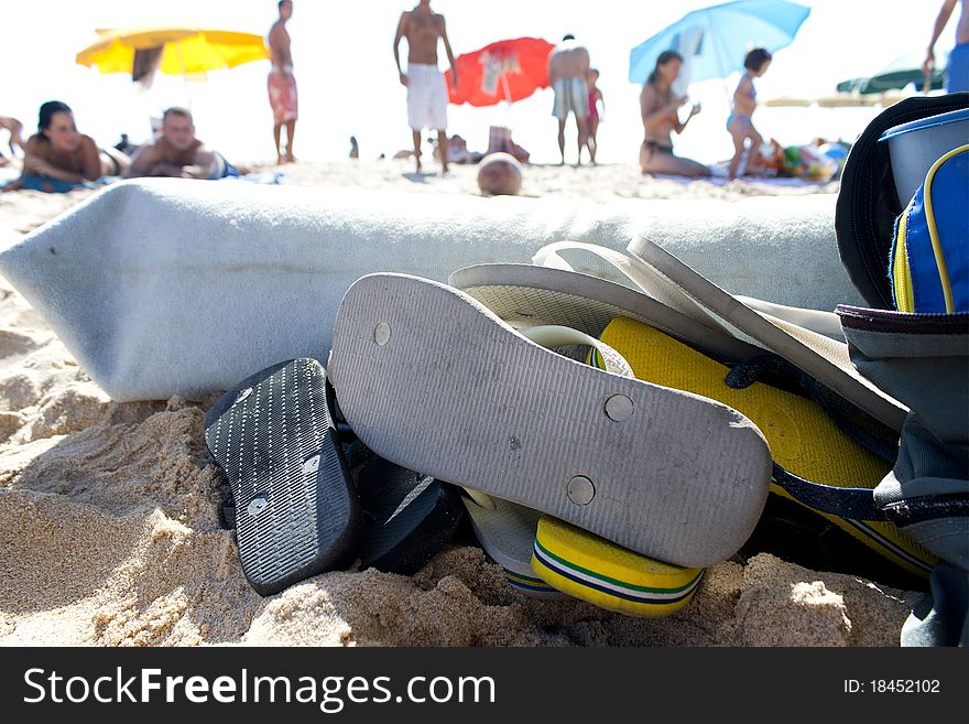 A pile of flip flops on the beach