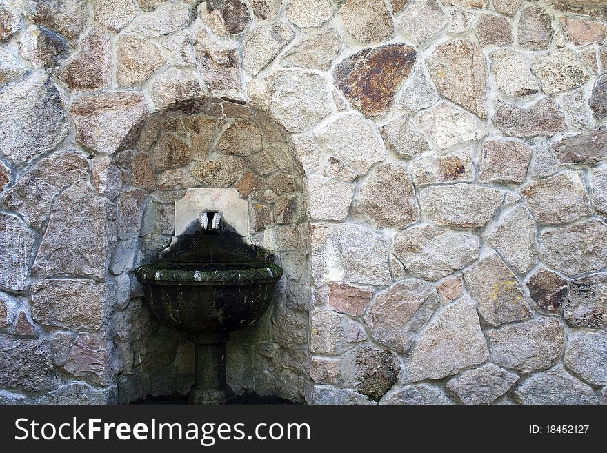One old fountain in on stone wall