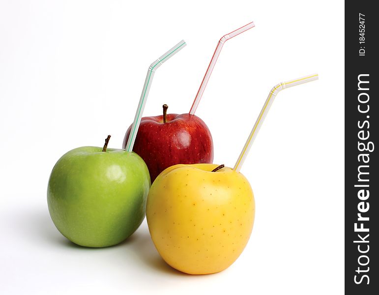 Three apples with straws on a white background