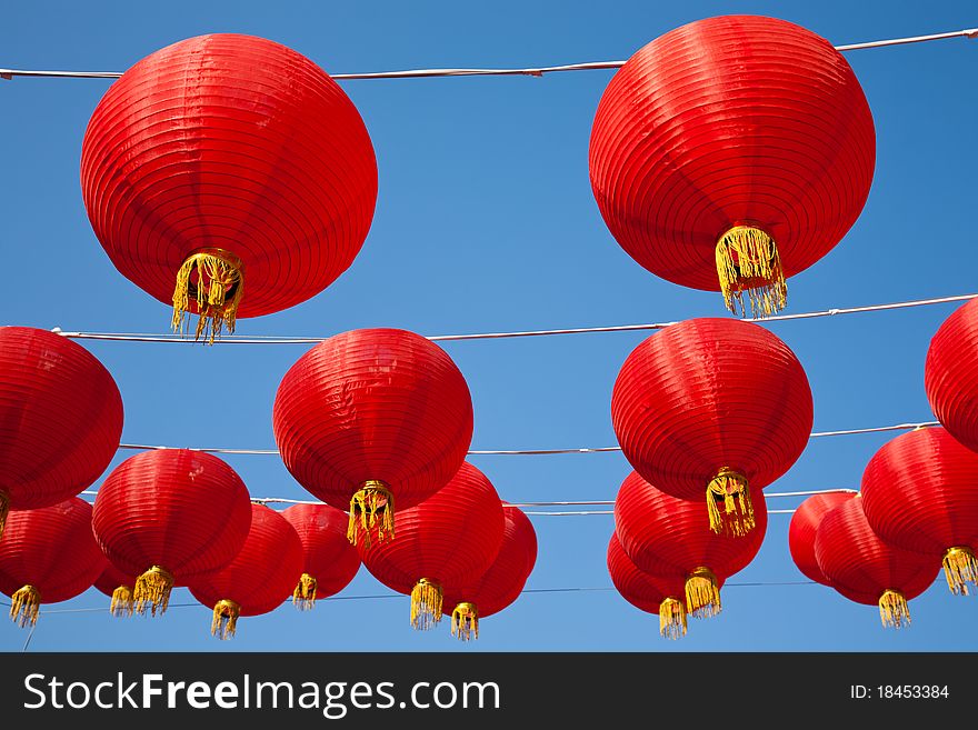 Chinese red lanterns hanging against bule sky