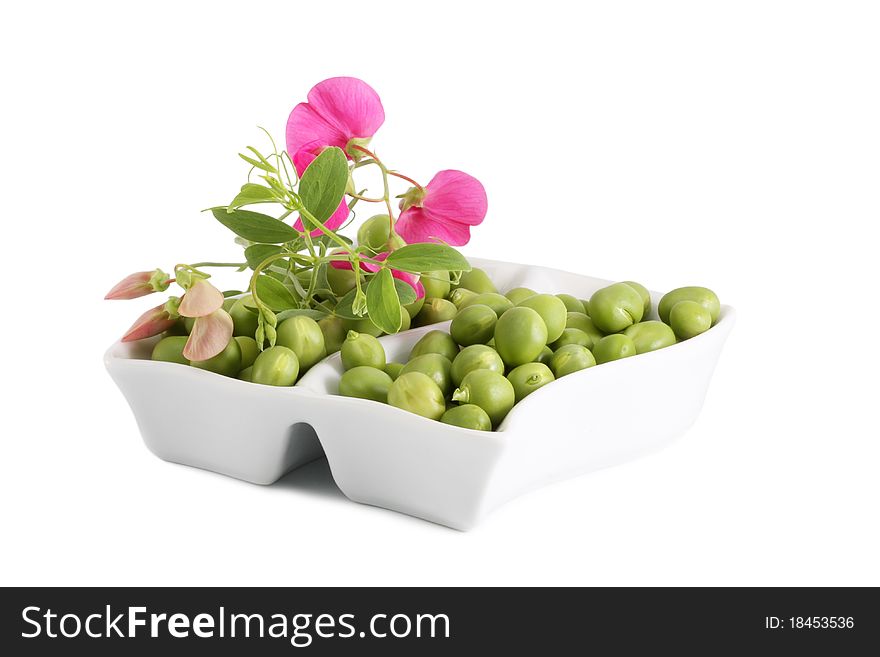 Green Peas and a branch with flowers on a white background