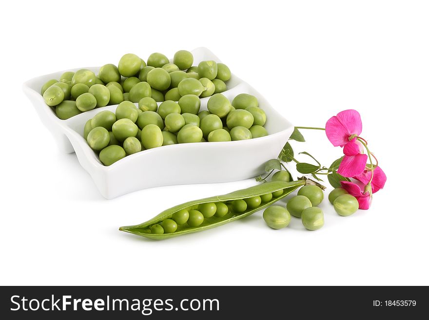 Green Peas and a branch with flowers on a white background