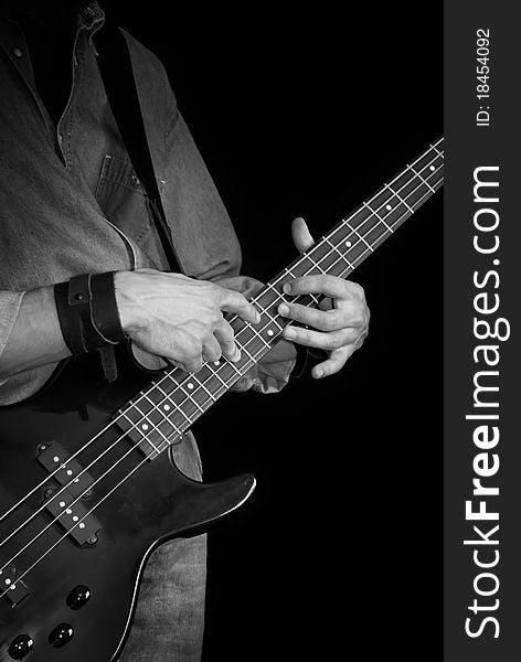 Electrical bass-guitar in male hands, black and white. Electrical bass-guitar in male hands, black and white