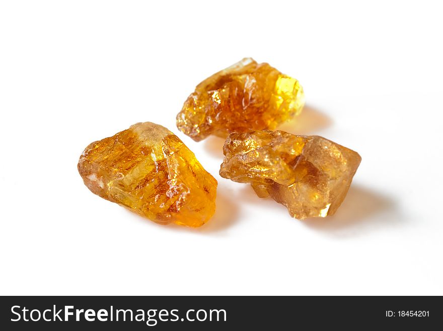 Brown caramelized sugar on white background. Brown caramelized sugar on white background