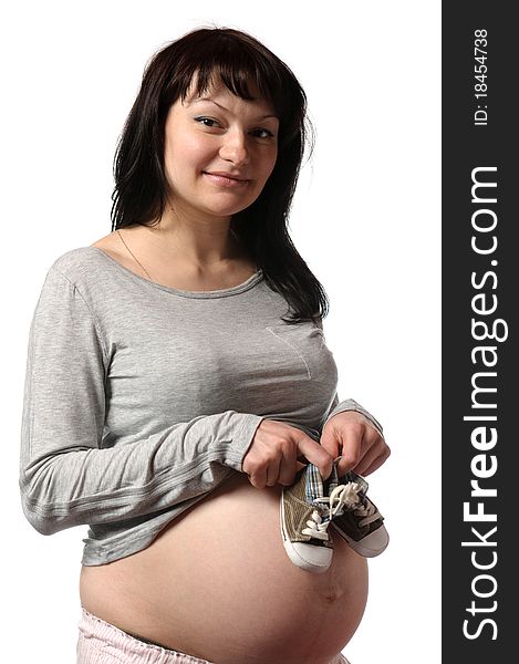 Pregnant young woman with small shoes
