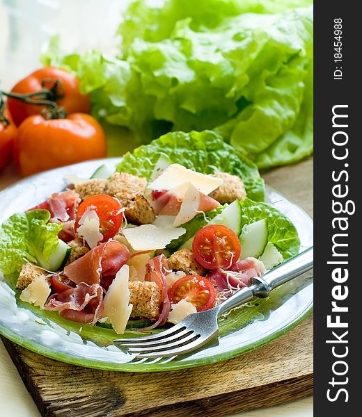 Fresh salad from vegetables, cheese and ham