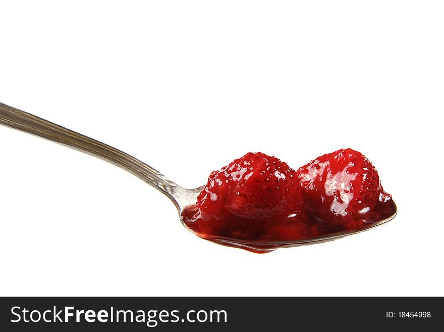 Defrosted strawberries on spoon isolated on white background
