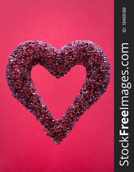 Jeweled heart on red isolated