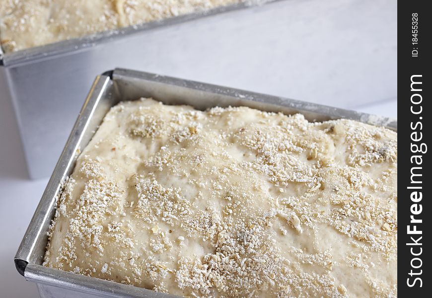 Unbaked olive bread loaf on white background