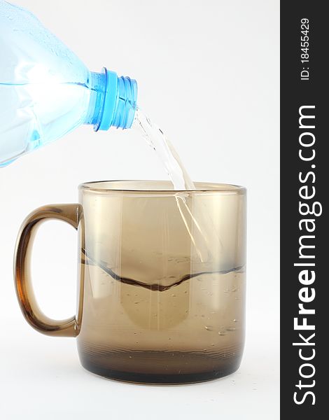 Pouring Water into Cup, isolated on the white background.