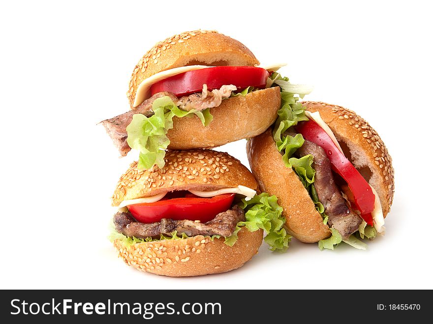 Three hamburger with vegetables on a white background