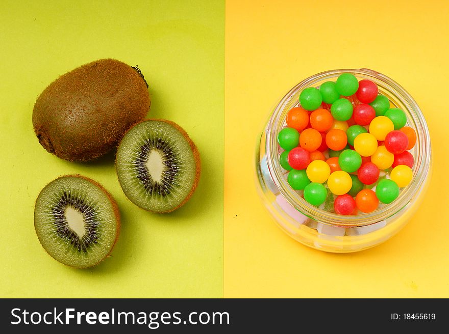 Contrast of kiwi fruit and candy. Contrast of kiwi fruit and candy