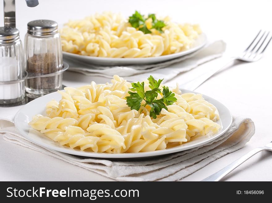 Two plates of pasta with parsley